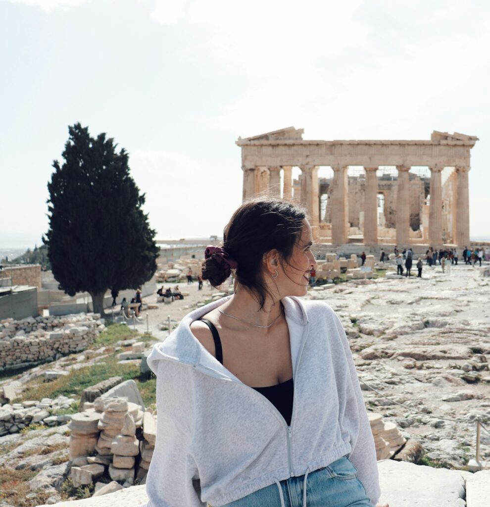 a woman standing in front of the part of a building